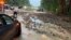 Vehicles come to a standstill near a washed-out and flooded portion of the Palisades Parkway just beyond the traffic circle off the Bear Mountain Bridge, July 9, 2023, in Orange County, New York.