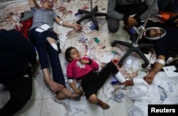 Wounded Palestinians lie on the floor at Nasser Hospital, following Israeli strikes on Ma'an school east of Khan Younis, in the southern Gaza Strip, Dec. 5, 2023.