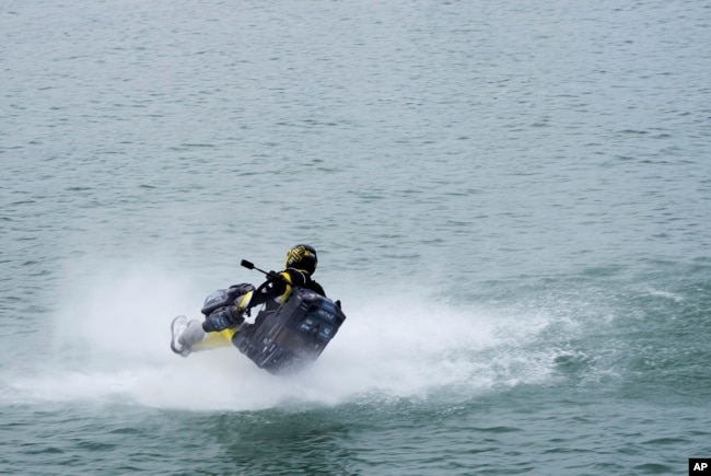 Emirati jet suit pilot Ahmed al-Shehhi crashes into the water during a race in Dubai, United Arab Emirates, Wednesday, Feb. 28, 2024. (AP Photo/Jon Gambrell)