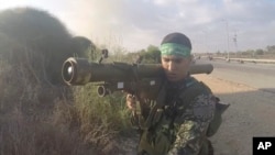 In this image from body camera video during the Oct. 7, 2023, surprise attack on Israel, a Hamas fighter holds a Russian-designed 9M32 Strela anti-aircraft missile. (South First Responders via AP)
