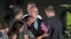 Reporter Evan Gershkovich is greeted by his parents and other family members on the tarmac at Andrews Air Force Base, Md., following his release as part of a 24-person prisoner swap between Russia and the United States, Aug. 1, 2024. 