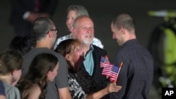 Reporter Evan Gershkovich is greeted by his parents and other family members on the tarmac at Andrews Air Force Base, Md., following his release as part of a 24-person prisoner swap between Russia and the United States, Aug. 1, 2024. 