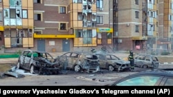 Firefighters extinguish burning cars in the courtyard of an apartment building after a missile attack by the Armed Forces of Ukraine on the city of Belgorod, Russia, Sept. 2, 2024.