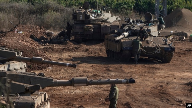 Israeli tanks are stationed near the Israeli border with Lebanon, Oct. 13, 2023.