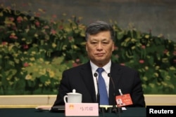 中国新疆维吾尔自治区党委书记马兴瑞在全国人大会议期间出席新疆代表团全体会议。（2024年3月7日）