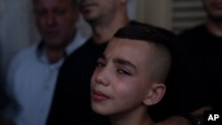 Mohammed, brother of Fares Sharhabil Abu Samra, 14, cries during his funeral in the West Bank city of Qalqilya on July 27, 2023. The Palestinian Health Ministry said that Abu Samra was killed by Israeli fire.