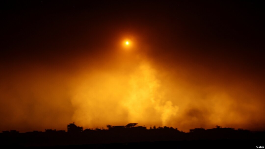 A flare falls over Gaza during the ongoing conflict between Israel and Hamas, as seen from southern Israel, Dec. 7, 2023.