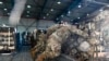 FILE - U.S. Air Force Airmen load pallets of ammunition to be transferred to a C-130 Hercules on Ramstein Air Base, Germany, Aug. 7, 2022.