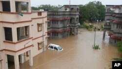 A car is partially submerged outside the quarters of civil hospital employees following landfall of Cyclone Biparjoy at Mandvi in Kutch district of Western Indian, June 16, 2023.