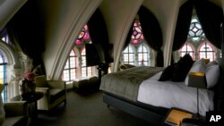 Sunlight filters in through stained glass windows in a guest room at the Martin's Patershof hotel in the center of Mechelen, Belgium, June 19, 2023.