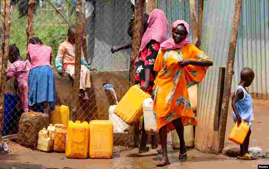 Sudanese refugees collect water from a tap at the Gorom Refugee camp hosting Sudanese refugees, near Juba, South Sudan.