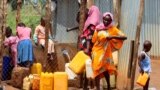 FILE - Sudanese refugees collect water from a tap at the Gorom Refugee camp hosting Sudanese refugees near Juba, South Sudan, June 20, 2023. 