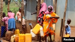 FILE - Sudanese refugees collect water from a tap at the Gorom Refugee camp hosting Sudanese refugees near Juba, South Sudan, June 20, 2023. 