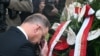 Poland's President Andrzej Duda makes the sign of the cross as he lays a wreath at the monument in memory of victims of the Nazi bombing on September 1, 1939, following the ceremony in Wielun, Sept. 1, 2024. 