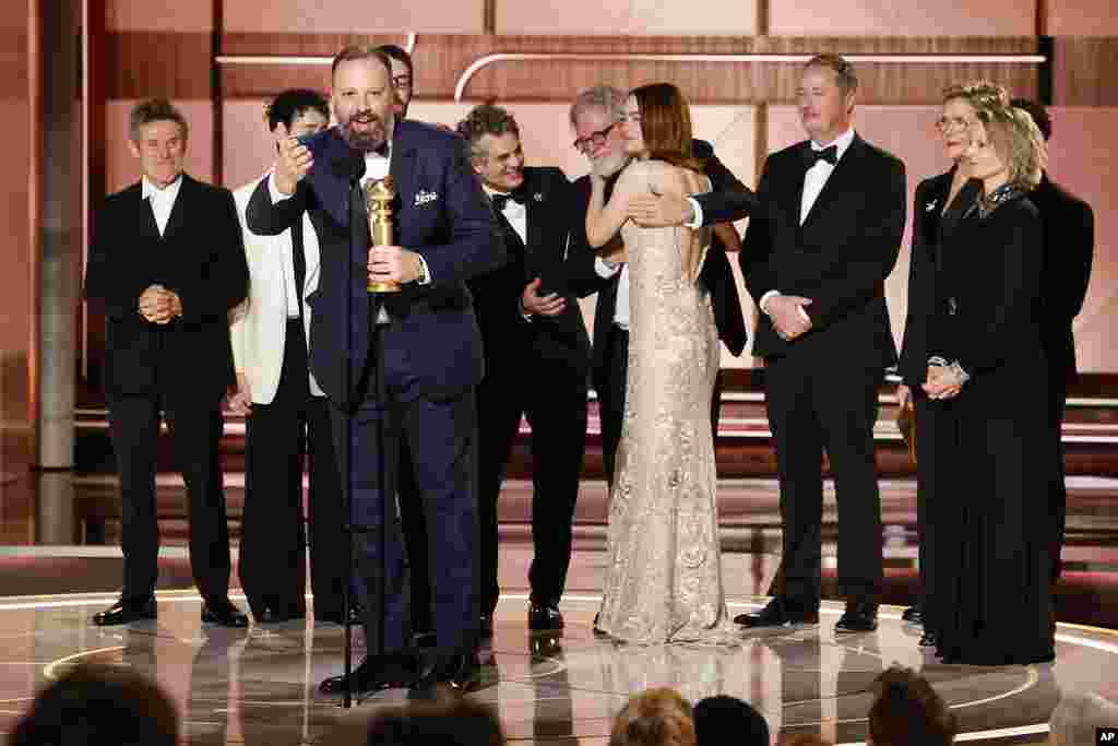 This image released by CBS shows filmmaker Yorgos Lanthimos, foreground, with the cast as he accepts the award for best motion picture - musical or comedy for &quot;Poor Things&quot; during the 81st Annual Golden Globe Awards in Beverly Hills, Calif., on Sunday, Jan. 7, 2024.&nbsp;