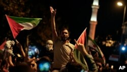 People chant anti-Israel slogans while waving Palestinian flags during a rally celebrating the attacks that the militant Hamas group carried out against Israel, in Istanbul, Turkey, Oct. 7, 2023. 