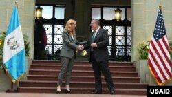 USAID Administrator Samantha Power shakes hands with Guatemalan President Bernardo Arévalo.