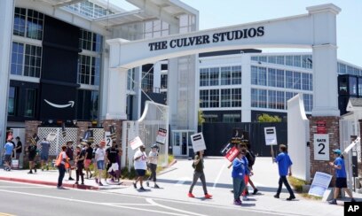 Picketers carry signs outside Amazon Studios in Culver City, California, July 17, 2023.
