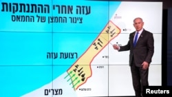 Israeli Prime Minister Benjamin Netanyahu stands before a map of the Gaza Strip, telling viewers how Hamas has imported arms into the territory since Israel's withdrawal in 2005, during a news conference in Jerusalem, Sept. 2, 2024. 