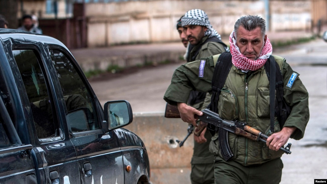 FILE - Christian fighters of Sutoro carry their weapons at a checkpoint in Tel Tamr, Syria, Feb. 25, 2015. Local reports said three members of Sutoro were killed in Turkish drone strikes on Derik, Syria, Feb. 28, 2024.
