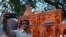 A person takes selfie in front of a replica of the Lord Ram temple in Ayodhya, which is on display outside India's ruling Bharatiya Janata Party office, in Mumbai, India, Jan. 16, 2024.