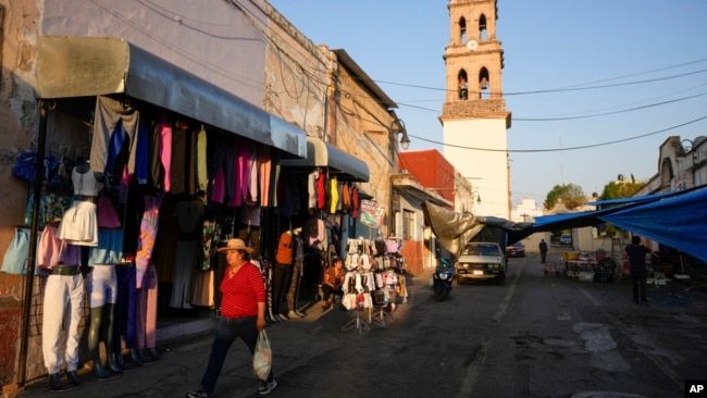 A woman walks in Maravatio, Michoacan state, Mexico, Feb. 27, 2024.