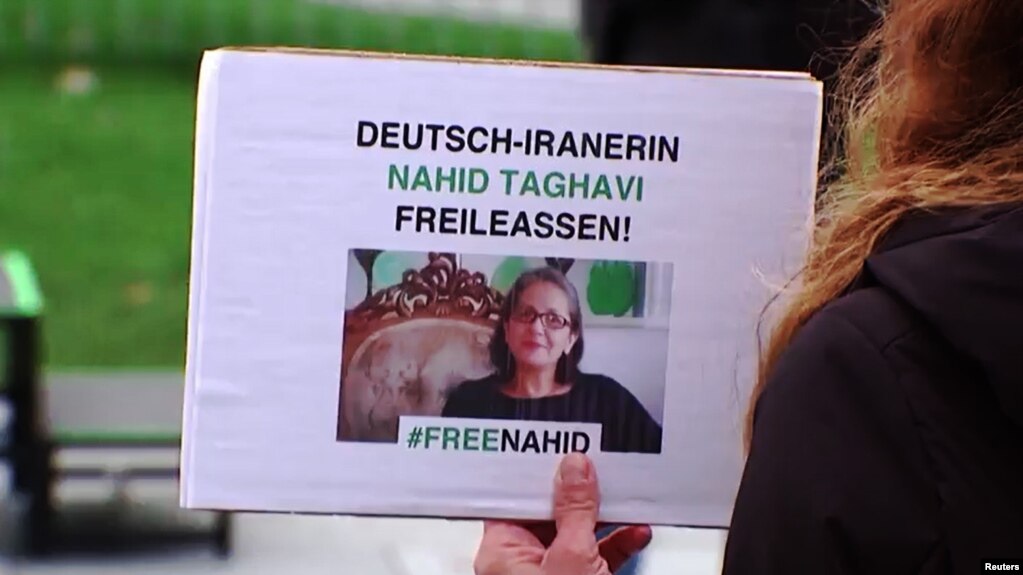 FILE - In a screen grab from video, a protester holds a sign demanding the German government do more for the release of German-Iranian national Nahid Taghavi, imprisoned in Iran, during a rally near the Chancellery in Berlin, Germany, Feb 22, 2023.