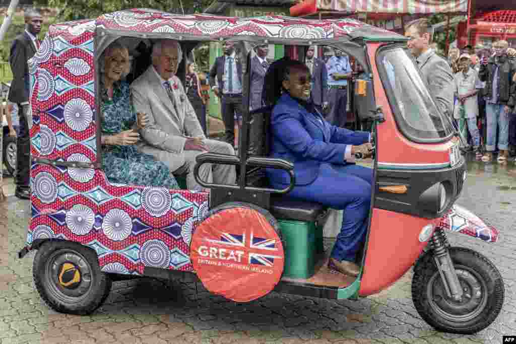 Britain&#39;s Queen Camilla and Britain&#39;s King Charles III sit in an electric tuktuk with a driver from the British High Commission Eunice Karanja during a visit to Fort Jesus, a UNESCO world heritage site, in Mombasa Old Town, Kenya. (Photo by Luis Tato / AFP)