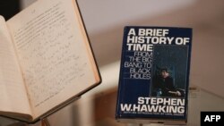 FILE - A picture shows the book 'A Brief History of Time' by theoretical physicist Stephen Hawking signed with a thumbprint at Christie's auction house in London, Oct. 30, 2018. 