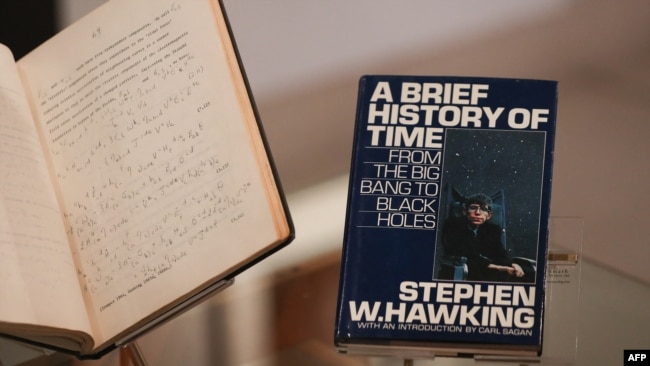 FILE - A picture shows the book 'A Brief History of Time' by theoretical physicist Stephen Hawking signed with a thumbprint at Christie's auction house in London, Oct. 30, 2018.