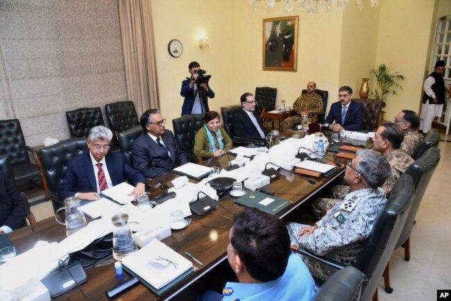 In this photo released by Pakistan's Prime Minister's office, caretaker Prime Minister Anwaar-ul-Haq Kakar, center right, chairs a meeting of the National Security Committee, in Islamabad, Pakistan, Jan. 19, 2024.