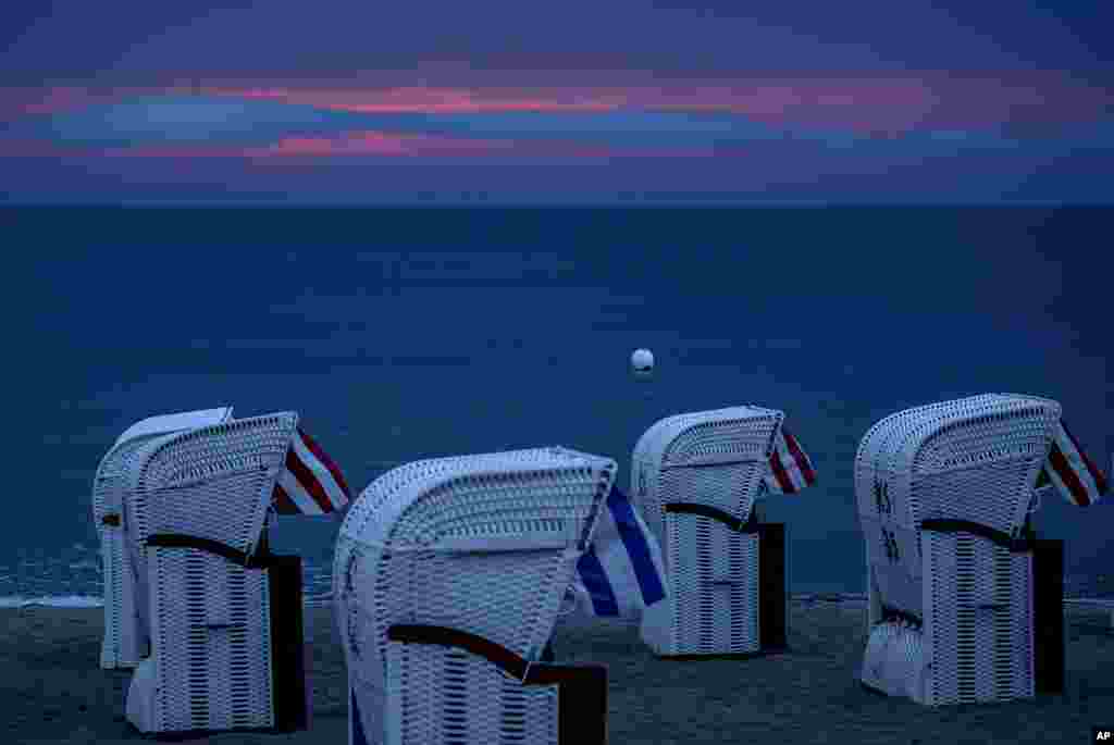 Beach chairs stand at the Baltic Sea in Timmendorfer Strand, Germany, after thunderstorms during the night, before sunrise.