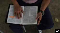 A young man who was imprisoned for belonging to a gang reads a Bible during family visiting hours at the “Vida Libre” or “free life,” rehabilitation center, in Santa Ana, El Salvador, April 29, 2023.