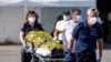 Paramedics carry an injured survivor of a shipwreck to an ambulance at the port in Kalamata town, about 240 kilometers (150miles) southwest of Athens, June 14, 2023.