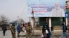 Paramilitary soldiers stand guard near a billboard ahead of Indian Prime Minister Narendra Modi's visit to Srinagar, in Indian-administered Kashmir, March 6, 2024. 