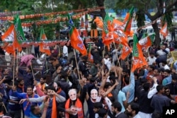 FILE - Supporters of India's ruling Bharatiya Janata Party, or BJP, celebrate early leads for the party in Rajasthan state elections in Jaipur, India, Dec.3, 2023. (AP Photo/Deepak Sharma)