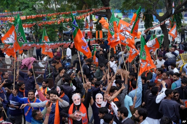FILE - Supporters of India's ruling Bharatiya Janata Party, or BJP, celebrate early leads for the party in Rajasthan state elections in Jaipur, India, Dec.3, 2023. (AP Photo/Deepak Sharma)