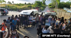 Keluarga dua PMI, Imanuel Taopan dan Jhoni Lopo berkumpul dan mendoakan jenazah keduanya, sebelum dibawa pulang dari Bandara El Tari Kupang pada 1 Mei 2023. (Foto: BP3MI NTT)