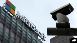FILE - A security surveillance camera is seen near the Microsoft office building in Beijing, China, July 20, 2021.