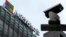FILE - A security surveillance camera is seen near the Microsoft office building in Beijing, China, July 20, 2021.