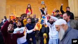 FILE - Protesters burn flags of Sweden and the Netherlands outside Mohammad al-Amin Mosque to denounce the desecration of the Quran, Islam's holy book, by a far-right activists in the European countries, in Beirut, Lebanon, Jan. 27, 2023.