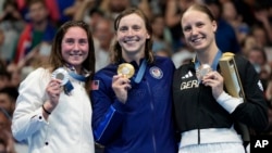 Katie Ledecky, center, of the U.S., Anastasiia Kirpichnikova, left, of France and Isabel Gose of Germany are pictured after the women's 1500-meter freestyle final at the 2024 Summer Olympics, July 31, 2024, in Nanterre, France.