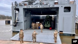 In this photo provided by U.S. military's Central Command, U.S. Army Vessel 'General Frank S. Besson' prepares to depart Joint Base Langley-Eustis, Virginia, March 9, 2024. (U.S. Central Command via AP)