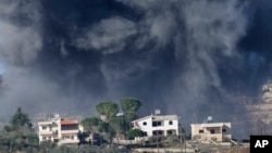 Black smoke rises from an Israeli airstrike on the outskirts of Aita al-Shaab, a Lebanese border village with Israel, Nov. 21, 2023.