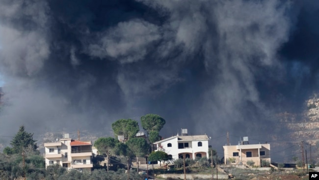 Black smoke rises from an Israeli airstrike on the outskirts of Aita al-Shaab, a Lebanese border village with Israel, Nov. 21, 2023.