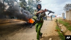 A riot policeman reloads a tear gas grenade launcher during clashes with protesters in the Kibera area of Nairobi, Kenya, July 19, 2023.
