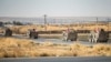 FILE - U.S. military vehicles patrol along a road near the town of Tal Baydar in Syria's northeastern Hasakeh province, Oct. 12, 2019. A one-way drone attack at Tal Baydar in Syria on Nov. 17, 2023, damaged infrastructure at the base and injured a service member.