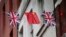 FILE - Chinese and British flags fly in London's Chinatown, Britain.