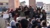 Demonstrators rally in the town of Idlib in Syria's northwestern Idlib province on March 1, 2024, to protest against Hayat Tahrir al-Sham, an Islamist group led by al-Qaida's former Syria branch, and calling for the overthrow of the group's leader.
