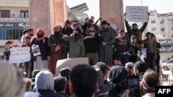 Demonstrators rally in the town of Idlib in Syria's northwestern Idlib province on March 1, 2024, to protest against Hayat Tahrir al-Sham, an Islamist group led by al-Qaida's former Syria branch, and calling for the overthrow of the group's leader.